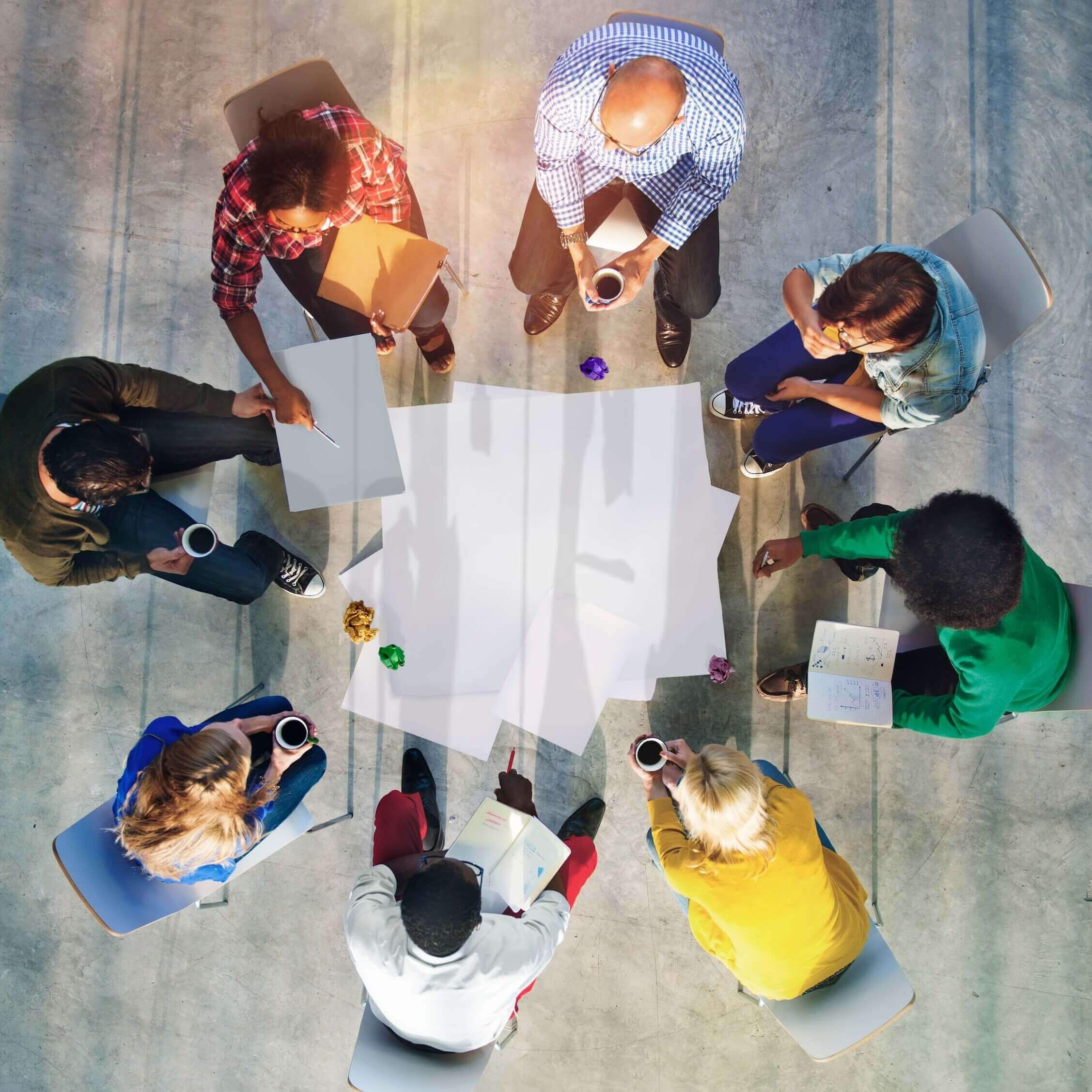overhead view of people in circle, making plans